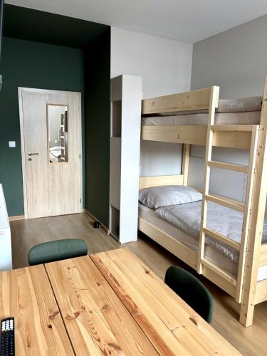 a room with bunk beds and a table with chairs at el Gotel in Čadca