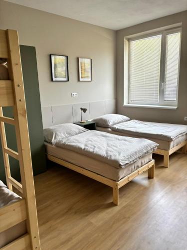 a room with two beds and a bunk bed at el Gotel in Čadca