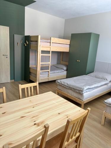 a room with two bunk beds and a table at el Gotel in Čadca