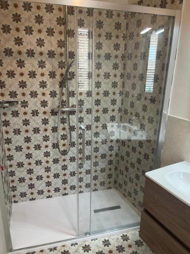 a shower with a glass door in a bathroom at Camere al Borgo Affittacamere in Monteprandone