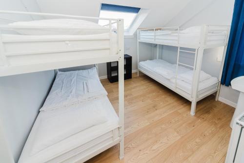 two bunk beds in a room with a wooden floor at Broadford Backpackers Hostel in Broadford