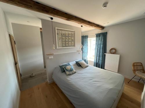 a bedroom with a bed with two pillows on it at Maison Jean-Phi in Libin