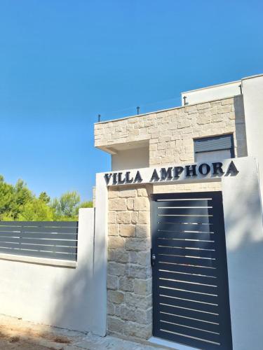 a building with a garage door and a sign that reads villa antipota at Villa Amphora in Vir