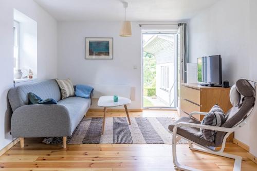 a living room with a couch and a chair at Ferienhaus Andersson in Klütz