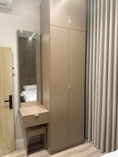 a bathroom with a cabinet and a mirror at المنزل الآمن in Medina