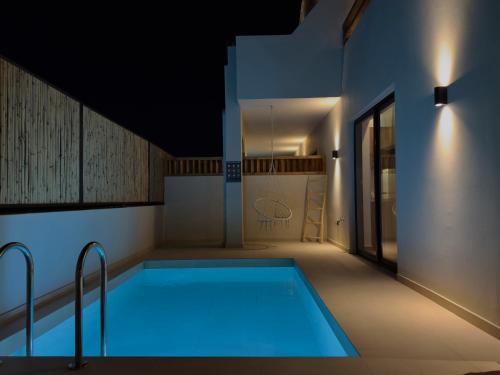 a swimming pool in the middle of a house at Yucca Calma in Rhodes Town