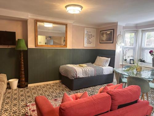 a living room with a bed and a table at La Di Da Hotel beach town in Bournemouth