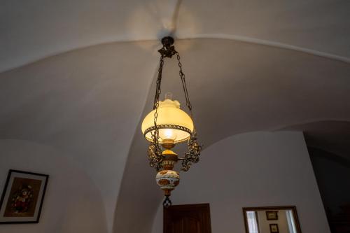 a chandelier hanging from a ceiling in a room at Pensiunea Bastion - La Strada - in Sighişoara