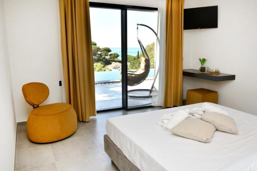 a bedroom with a bed and a view of the ocean at Moddissi Charme in Trappola