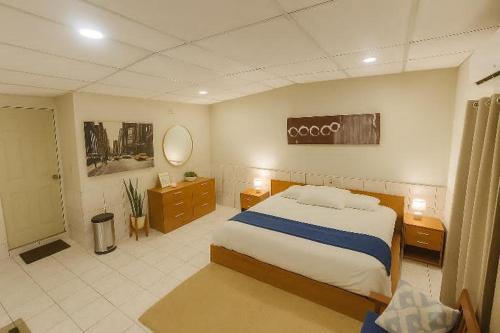 a bedroom with a large bed and a bathroom at Suite 608 Ciudad Jardín San Miguel in San Miguel
