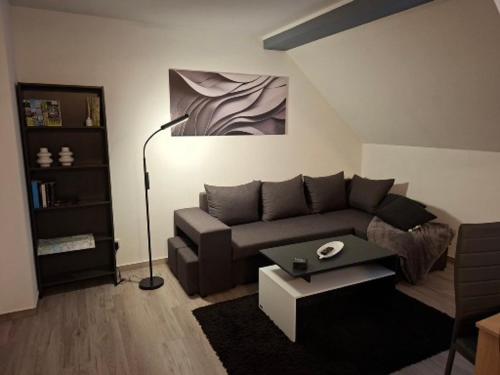 a living room with a couch and a table at Ferienwohnung Familie Siegl in Pouch