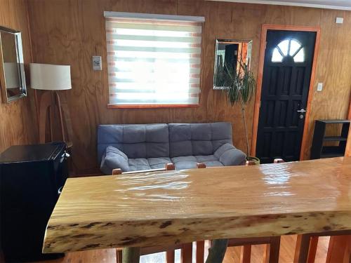 a living room with a couch and a table at Pichihuape Lodge in Valdivia
