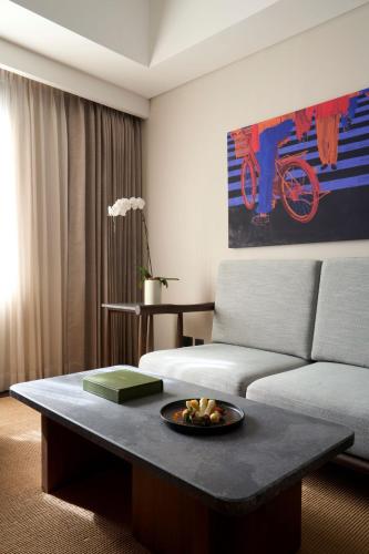 a living room with a couch and a table at Seda Abreeza - Newly Renovated in Davao City