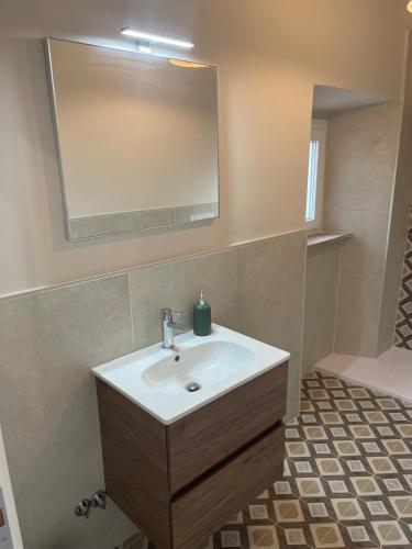 a bathroom with a sink and a mirror at Camere al Borgo Affittacamere in Monteprandone