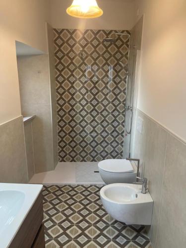 a bathroom with a sink and a toilet and a shower at Camere al Borgo Affittacamere in Monteprandone