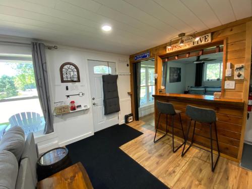 a living room with a bar in a tiny house at Our Place Up North BnB in Huntsville
