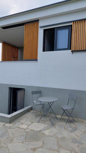 two chairs and a table in front of a house at Modern Summer House Kalimera in Epanomi