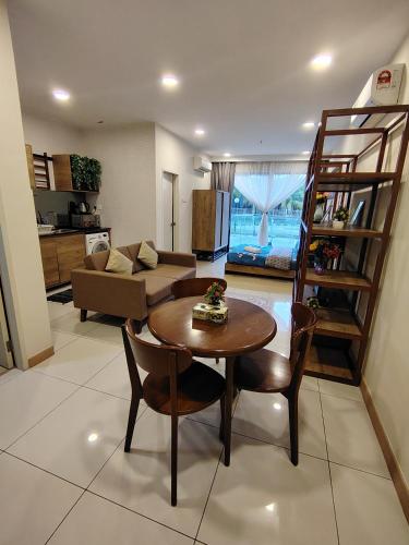 a living room with a table and a couch at Timurbay Seafront By Moonlight in Kuantan