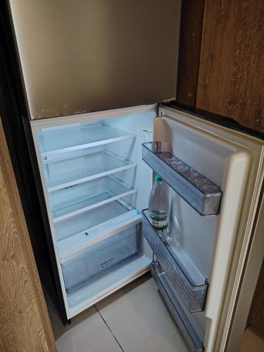 an empty refrigerator with its door open in a kitchen at Timurbay Seafront By Moonlight in Kuantan