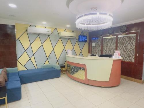 a lobby with a waiting area with a bar in it at Star Emirates Downtown Hotel Salalah in Salalah