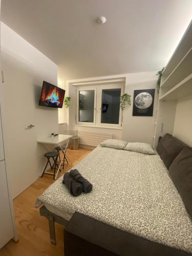 a bedroom with a large bed and a couch at City Studio 2 in Zürich