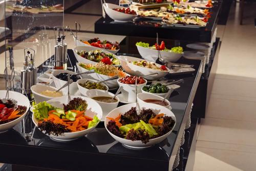 a buffet with many bowls of food on a table at Villa (second floor) in CRYSTAL in Bakuriani