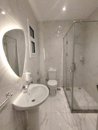 a bathroom with a sink and a shower and a toilet at DHB Stays Luxury Downtown Apartment 1BR 89 in Cairo