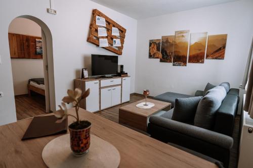 a living room with a couch and a table at Hotel Garni Familie Gruber in Spital am Pyhrn