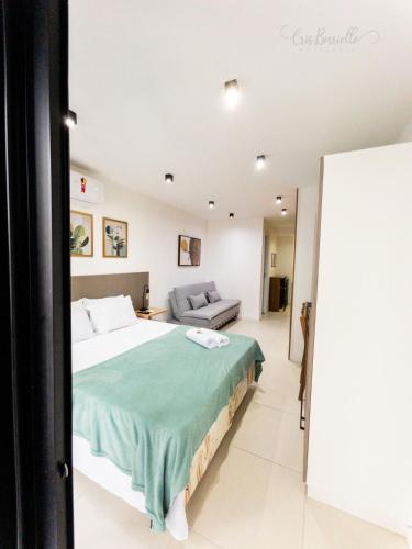 a bedroom with a large bed and a couch at Skylux 1608 in Rio de Janeiro
