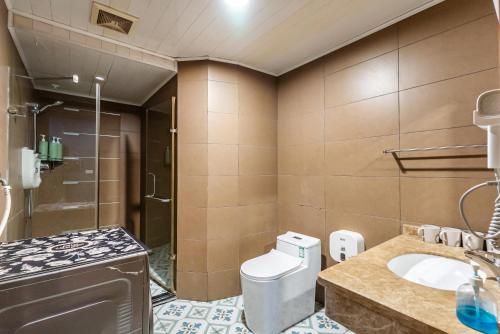 a bathroom with a toilet and a sink and a shower at Misty Nest High Altitude River View B&B Hongyadong Branch in Chongqing