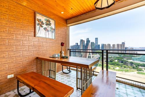 a room with a table and a balcony with a view at Misty Nest High Altitude River View B&B Hongyadong Branch in Chongqing
