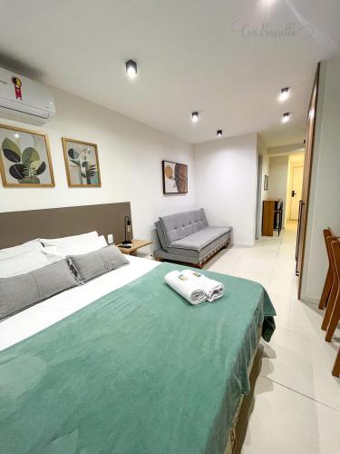 a bedroom with a large bed and a couch at Skylux 1608 in Rio de Janeiro