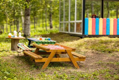 a picnic table in a park with a playground at Villa (second floor) in CRYSTAL in Bakuriani