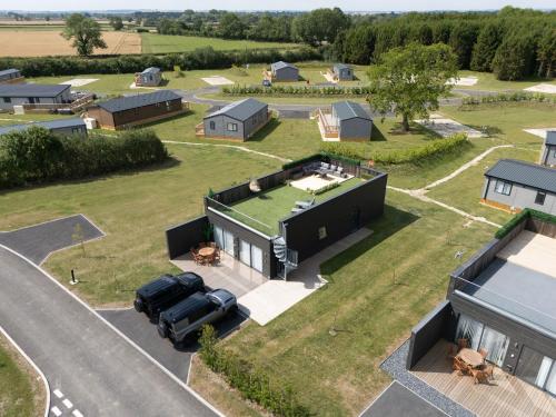 an aerial view of a house with a car parked on the driveway at Host & Stay - Dalby Lodge in Pickering
