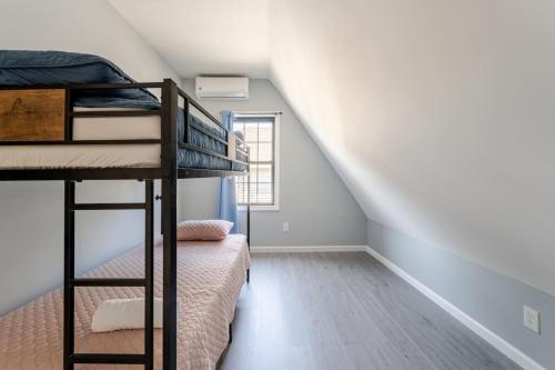 a bedroom with two bunk beds and a staircase at Modern House in Black Rock in Bridgeport