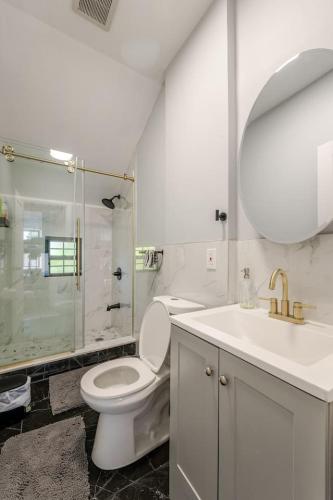 a bathroom with a toilet and a sink and a shower at Modern House in Black Rock in Bridgeport
