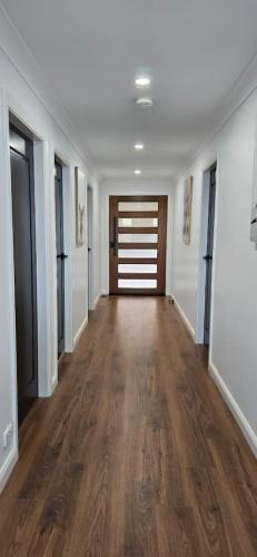 an empty hallway with wood floors in a house at Weemilah Spectacular Valley and Escarpment Views in Mount Victoria