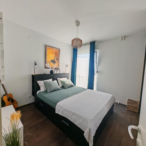 a bedroom with a large bed with blue curtains at The Golden View Apartment in Split