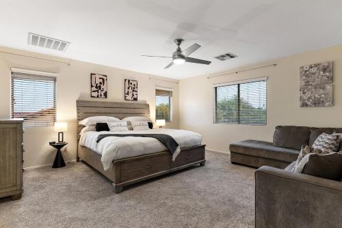 a bedroom with a bed and a couch at Mountain View Retreat Pool, Firepit Pool table Fun in Casa Grande