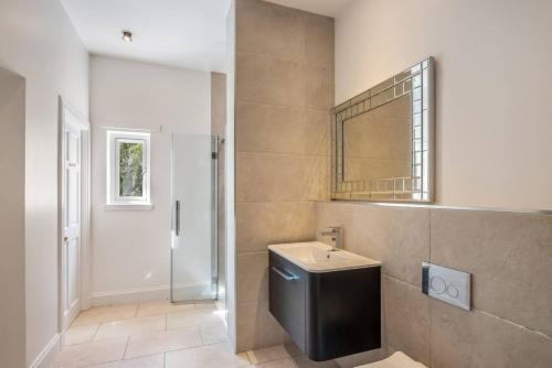 a bathroom with a toilet and a sink and a mirror at Balbirnie Mill, Brechin. in Angus