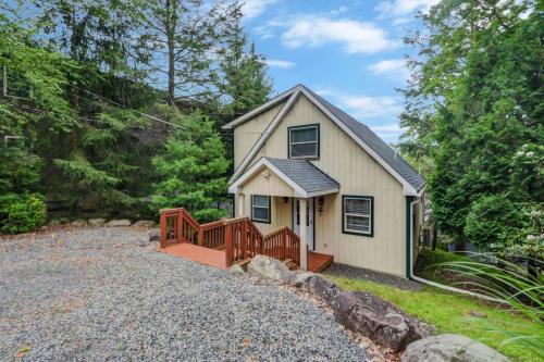 a small house with a porch and a wooden ramp at beautiful lakefront lodge in Lake Harmony