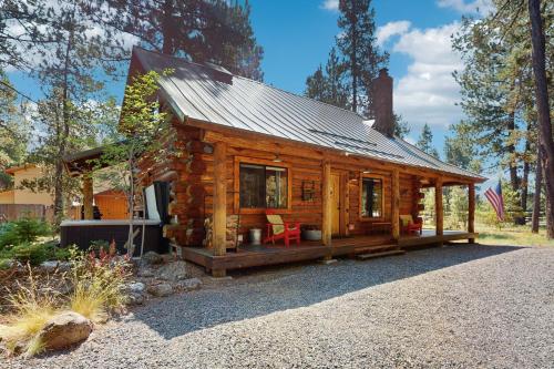 a log cabin with a metal roof at Sunriver Log Cabin in Bend