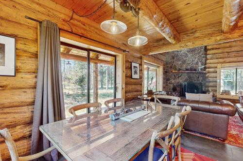a dining room with a large wooden table and chairs at Sunriver Log Cabin in Bend
