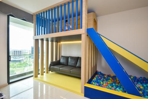 a play room with a bunk bed and a couch at Macrolink Medini Theme Suite by Nest Home - Near Legoland in Iskandar Puteri