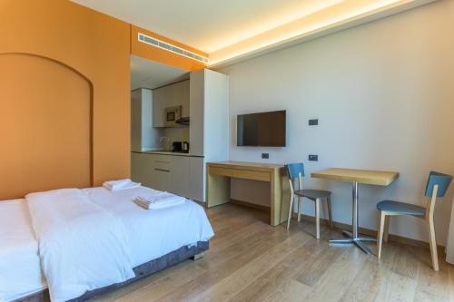 a bedroom with a bed and a desk and a table at Jounieh Living - Residences by Local Host in Ed Dkârîne