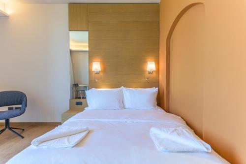 a large white bed in a hotel room at Jounieh Living - Residences by Local Host in Ed Dkârîne