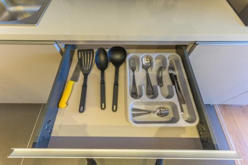 a drawer filled with utensils in a kitchen at Jounieh Living - Residences by Local Host in Ed Dkârîne