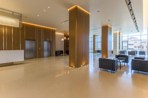 a lobby with chairs and tables in a building at Jounieh Living - Residences by Local Host in Ed Dkârîne