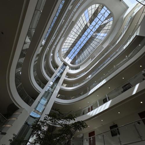 a spiral staircase in a building with a glass ceiling at Hotel Atrium Plaza in Barranquilla