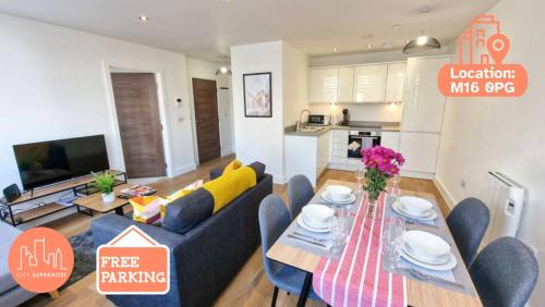 a living room with a blue couch and a table at Free Parking: Old Trafford Apartment in Manchester
